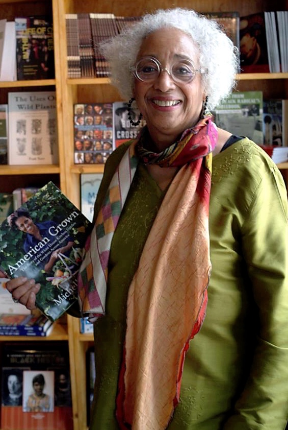 Source Booksellers owner, Janet Webster Jones, stands in front of a bookshelf.