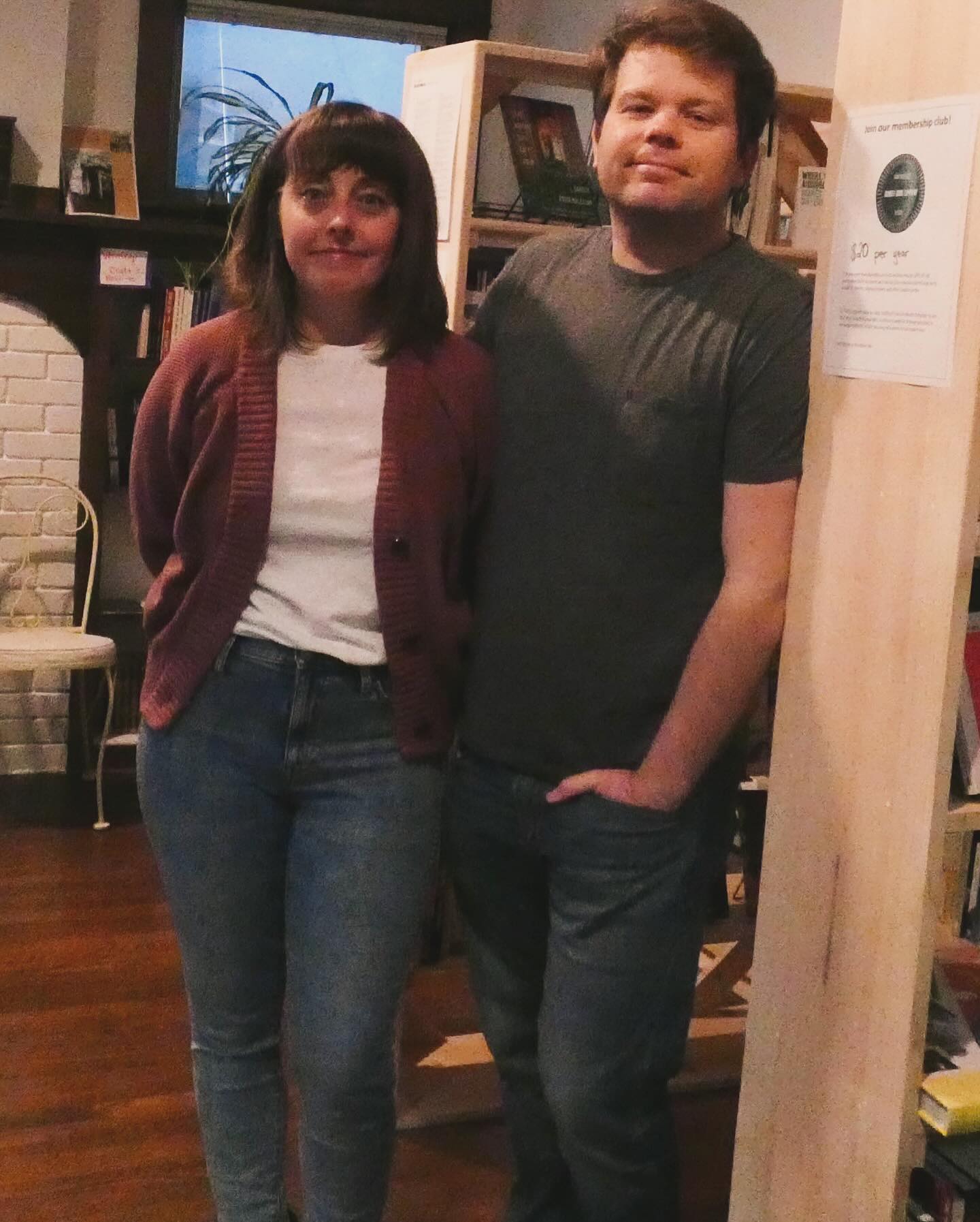 Nicole and Ted Wheeler stand in front of a row of bookshelves.